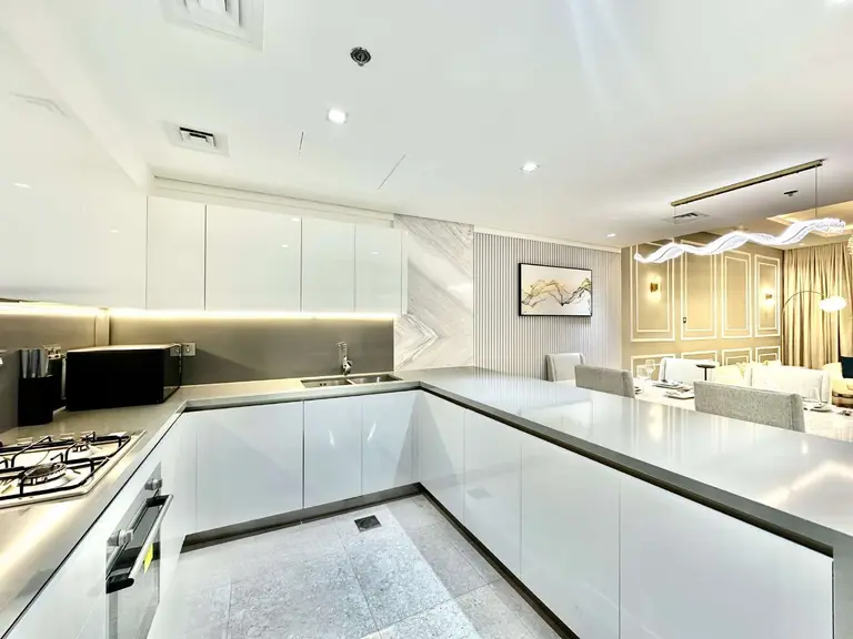 U-shaped kitchen with under-cabinet lighting, open to the dining room