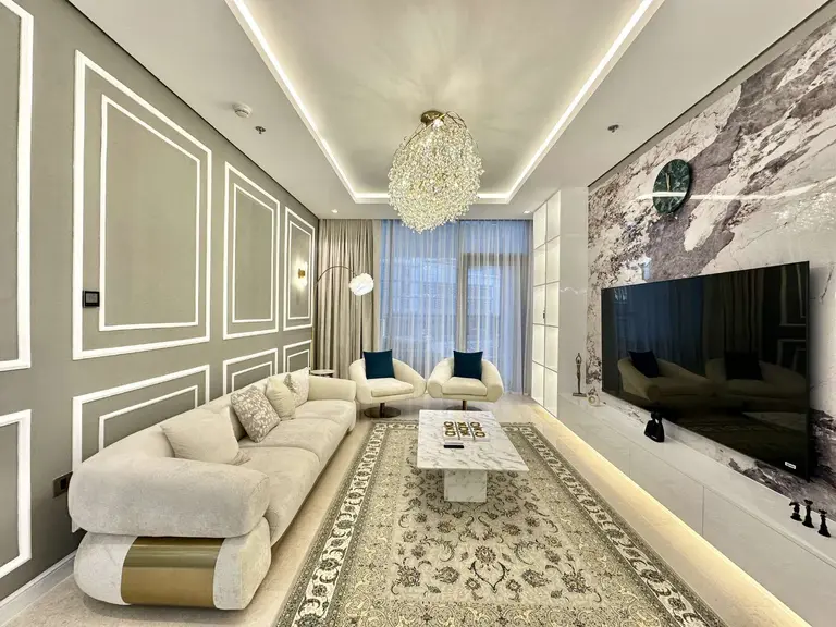 Sofa, armchairs and coffee table beneath a chandelier